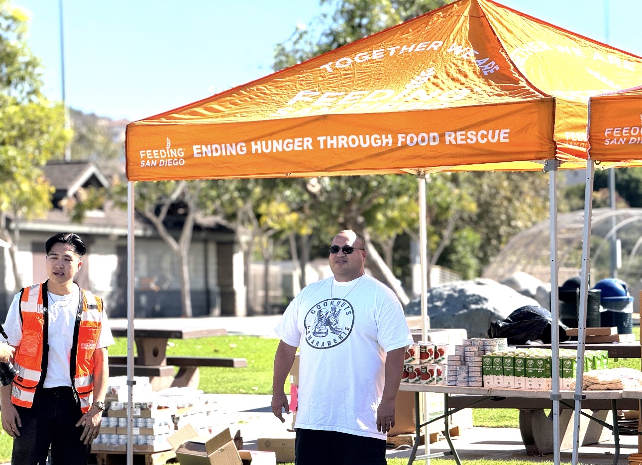 Angus Hsieh of Feeding San Diego and Jeff Mendez of Cookouts and Camaraderie serving food at a community hunger-relief event